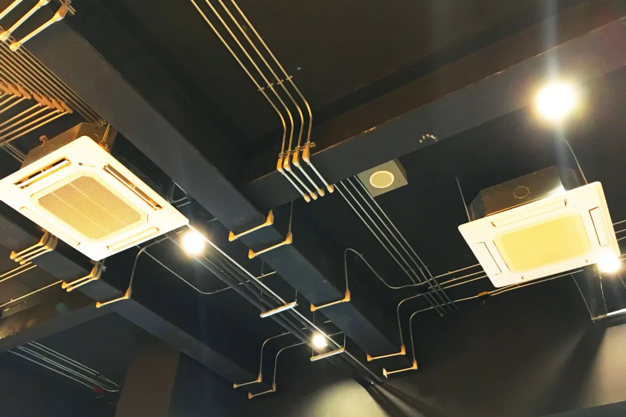 Soffitto industriale con condotti, climatizzatori e luci