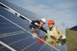 Tecnici ispezionano pannelli solari in un impianto fotovoltaico