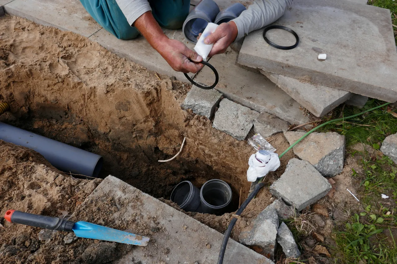 Tecnico lubrifica guarnizione per tubazioni fognarie interrate