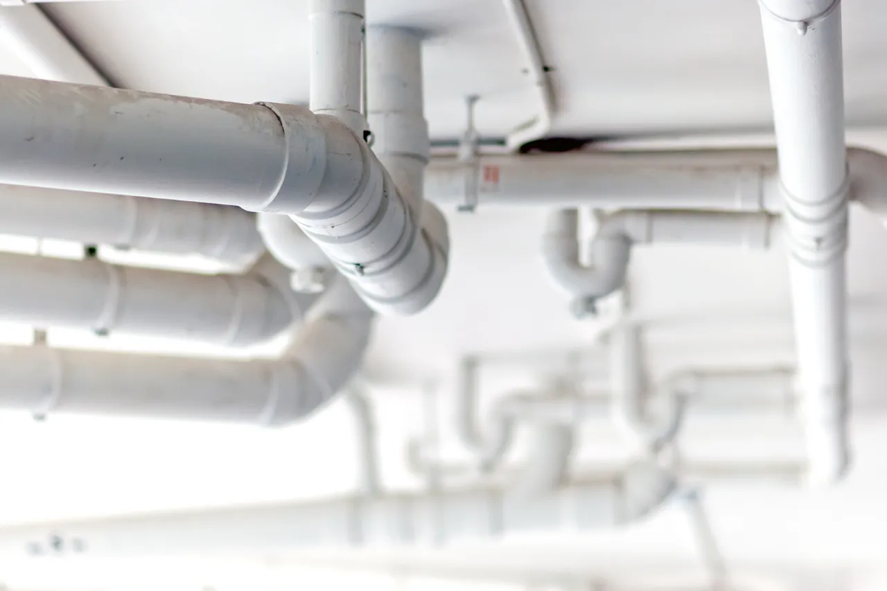Rete di tubazioni bianche installate sul soffitto