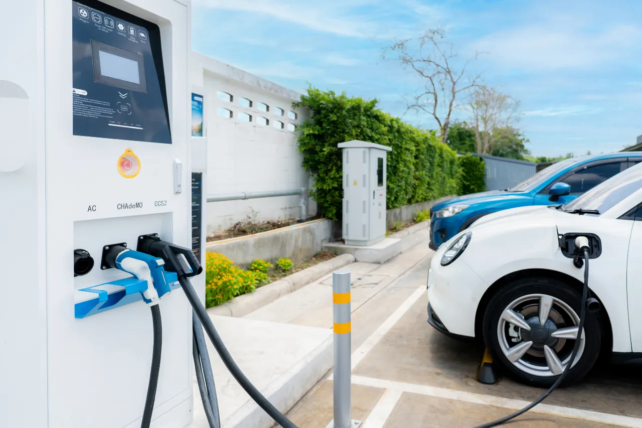 Auto elettrica bianca in ricarica presso colonnina pubblica