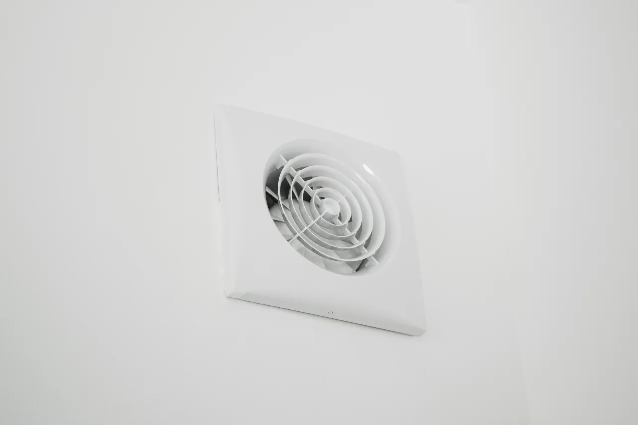 Griglia di ventilazione bianca installata su parete